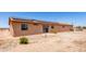 Backyard view showcasing the exterior, solar panels, and desert landscape at 31515 W Buchanan St, Buckeye, AZ 85326