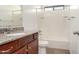 Bathroom with wood cabinets and a shower over tub combination at 31515 W Buchanan St, Buckeye, AZ 85326