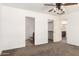 Bedroom showcases neutral carpet, a ceiling fan, and access to a closet and bathroom at 31515 W Buchanan St, Buckeye, AZ 85326