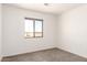 Bedroom features neutral carpet and a large window that provides plenty of natural light at 31515 W Buchanan St, Buckeye, AZ 85326