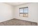 Bright bedroom features neutral carpet and a window offering beautiful natural light at 31515 W Buchanan St, Buckeye, AZ 85326