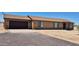 Single story home showcasing a two-car garage and a desert landscape at 31515 W Buchanan St, Buckeye, AZ 85326