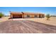 Desert property with rock driveway and neutral-colored single-story home at 31515 W Buchanan St, Buckeye, AZ 85326