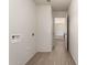 Hallway shows wood-look tile and leads into an adjoining room at 31515 W Buchanan St, Buckeye, AZ 85326