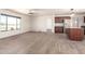 Open concept kitchen area featuring dark cabinets, natural light and wood look flooring at 31515 W Buchanan St, Buckeye, AZ 85326