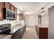 Open kitchen showcases granite countertops, wood cabinets, stainless steel appliances, and a large island at 31515 W Buchanan St, Buckeye, AZ 85326