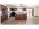 Bright kitchen featuring wood cabinets, a large island with granite countertops, and stainless steel appliances at 31515 W Buchanan St, Buckeye, AZ 85326
