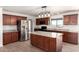 Kitchen featuring stainless steel appliances, dark wood cabinets, and center island at 31515 W Buchanan St, Buckeye, AZ 85326