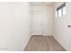 Mudroom with wood-look tile flooring, window, and exterior door at 31515 W Buchanan St, Buckeye, AZ 85326