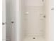 An all-white shower stall with built-in shelving adds practicality at 31515 W Buchanan St, Buckeye, AZ 85326