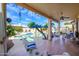 Covered backyard patio with comfortable seating and a view of the sparkling pool at 316 W Anderson Ave, Phoenix, AZ 85023