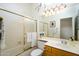 Clean bathroom with a shower-tub combo, wooden vanity, and neutral decor at 316 W Anderson Ave, Phoenix, AZ 85023