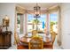 Light-filled breakfast nook with a round table, chairs, and backyard views at 316 W Anderson Ave, Phoenix, AZ 85023