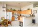 Bright eat-in kitchen features wooden cabinetry, a breakfast bar, and white appliances at 316 W Anderson Ave, Phoenix, AZ 85023