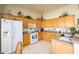 This kitchen features wooden cabinets, a white refrigerator, and a white range at 316 W Anderson Ave, Phoenix, AZ 85023