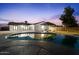Backyard pool with covered patio area and house reflection at dusk at 3506 W Yucca St, Phoenix, AZ 85029