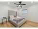 Modern bedroom features an upholstered headboard, wood floors, and a large window at 3506 W Yucca St, Phoenix, AZ 85029