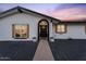 Charming single-story home with a welcoming front porch, manicured landscape, and a well-lit entrance at 3506 W Yucca St, Phoenix, AZ 85029