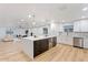 Modern kitchen featuring a large island, stainless steel appliances, and sleek white cabinets at 3506 W Yucca St, Phoenix, AZ 85029