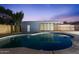 Backyard pool with clean blue water and a nearby workshop building under a beautiful dusk sky at 3506 W Yucca St, Phoenix, AZ 85029