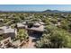 Expansive aerial view of the desert home, landscape, neighborhood and surrounding mountains at 41576 N 107Th Way, Scottsdale, AZ 85262
