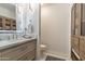 Bathroom showcasing a modern vanity, decorative tile, and wood linen closet at 41576 N 107Th Way, Scottsdale, AZ 85262