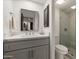 Bathroom showcasing a modern vanity, mirror, and a glass-enclosed shower at 41576 N 107Th Way, Scottsdale, AZ 85262