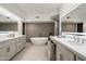 Modern bathroom featuring a soaking tub, dual vanities, and contemporary tile work at 41576 N 107Th Way, Scottsdale, AZ 85262