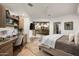 Bedroom with desk, ceiling fan, patio access, and stylish, light-filled decor at 41576 N 107Th Way, Scottsdale, AZ 85262