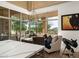 Bright breakfast nook with banquette seating, a modern chandelier, and mountain views through large windows at 41576 N 107Th Way, Scottsdale, AZ 85262
