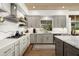 Well-lit kitchen with gray cabinetry, quartz countertops, stainless steel appliances, and a wood plank ceiling at 41576 N 107Th Way, Scottsdale, AZ 85262