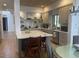 Modern kitchen with a large island, stainless steel appliances, open shelving, and stylish countertops at 41576 N 107Th Way, Scottsdale, AZ 85262