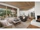 Open-concept living area with wood ceilings, hardwood floors, and an inviting seating arrangement at 41576 N 107Th Way, Scottsdale, AZ 85262