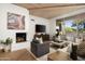 Cozy living room showcasing a fireplace, TV, wood ceilings, and comfortable seating arrangement at 41576 N 107Th Way, Scottsdale, AZ 85262