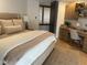Inviting bedroom featuring plush bedding, a bedside lamp, and a dedicated workspace at 41576 N 107Th Way, Scottsdale, AZ 85262