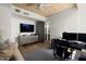 Inviting office with wood ceilings, large TV, modern desk, and comfortable sofa at 41576 N 107Th Way, Scottsdale, AZ 85262