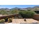 Inviting outdoor patio with wood table, cacti, and mountain views creates a serene space for relaxing and entertaining at 41576 N 107Th Way, Scottsdale, AZ 85262