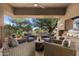 Relaxing outdoor seating area with comfortable furniture, fireplace and grill, ideal for gatherings at 41576 N 107Th Way, Scottsdale, AZ 85262