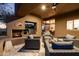 Cozy outdoor patio with a built-in fireplace, grill, and comfortable seating, creating an inviting space for relaxing and socializing at 41576 N 107Th Way, Scottsdale, AZ 85262