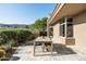 Inviting outdoor patio featuring a dining table, lush landscaping, and mountain views at 41576 N 107Th Way, Scottsdale, AZ 85262
