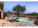 A tranquil pool and spa combination with a lush desert landscape providing a private backyard retreat at 41576 N 107Th Way, Scottsdale, AZ 85262