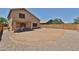 Spacious backyard featuring a covered patio, gravel landscaping, and a privacy wall at 4318 W Apollo Rd, Laveen, AZ 85339