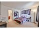 Comfortable bedroom with plush carpet, closet, ensuite bath and a soft natural light from a window at 4318 W Apollo Rd, Laveen, AZ 85339