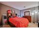 Charming bedroom with carpet floors, neutral walls, dark wood furniture, and a lit vanity with a mirror at 4318 W Apollo Rd, Laveen, AZ 85339