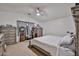 Bright bedroom with vaulted ceiling, plush carpet, and elegant grey furniture with a ceiling fan at 4318 W Apollo Rd, Laveen, AZ 85339
