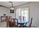 Cozy dining room with a wooden table, chairs, and natural light from the window at 4318 W Apollo Rd, Laveen, AZ 85339
