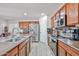 Spacious kitchen featuring stainless steel appliances, wood cabinets and tile flooring at 4318 W Apollo Rd, Laveen, AZ 85339