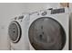 This laundry room features matching front-load washer and dryer units for convenient chores at 4318 W Apollo Rd, Laveen, AZ 85339