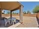 Covered patio area with outdoor seating overlooking a spacious, gravel-filled backyard at 4318 W Apollo Rd, Laveen, AZ 85339