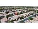 This aerial shot showcases a community with well-maintained homes, mature trees, and neatly landscaped yards in a residential neighborhood at 455 W Evergreen Pear Ave, Queen Creek, AZ 85140